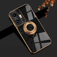 a close up of a phone with a gold ring on it