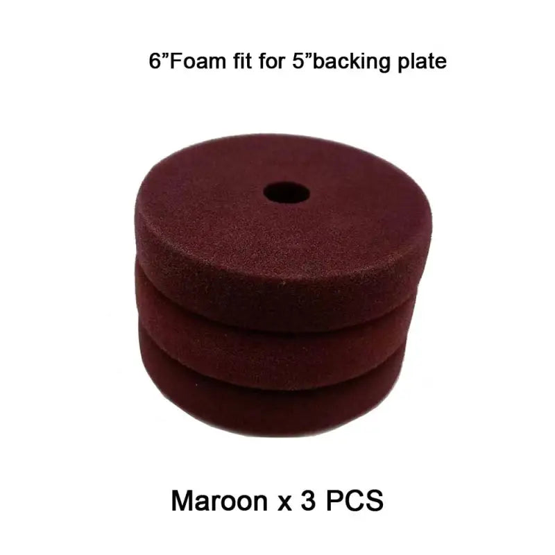 a close up of a pile of maroon colored foam discs