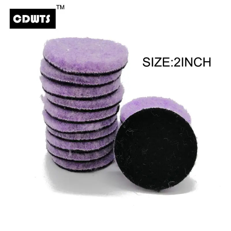 a pile of purple sponges with a black sponge on top