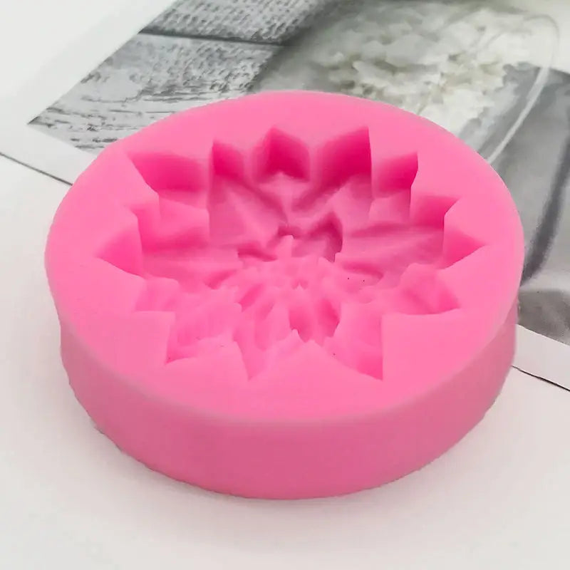 a close up of a pink cake mold with a flower design