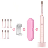 a close up of a pink electric toothbrush with a white tooth brush holder