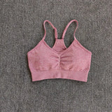 a close up of a pink bra top on a gray carpet