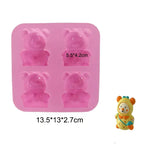 a close up of a pink ice tray with a teddy bear mold