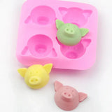 a close up of a pink ice tray with a pig and a piggy