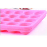 a close up of a pink ice tray with a hole in it