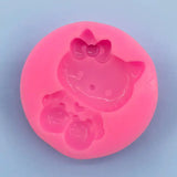 a close up of a pink hello kitty mold with a bow