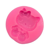 a close up of a pink hello kitty mold with a cat on it