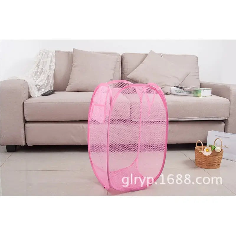 a close up of a pink mesh bag on a floor near a couch