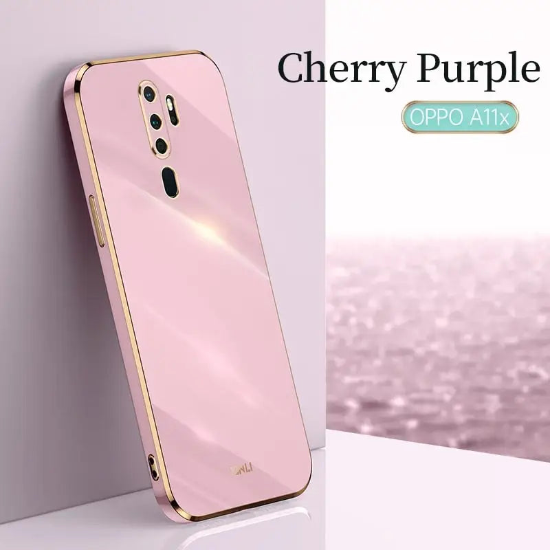 a close up of a pink phone with a cherry purple background