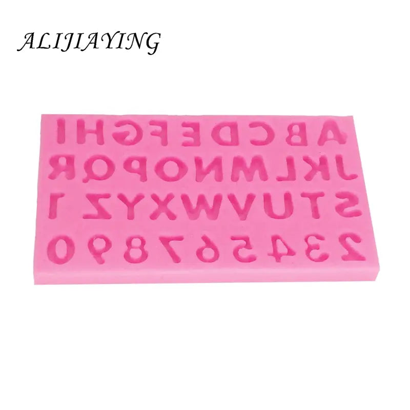 a close up of a pink plastic alphabet and numbers mold