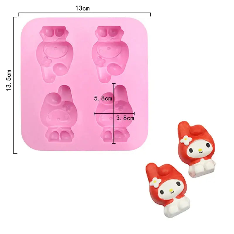 a close up of a pink plastic mold with a red and white cat