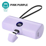 a close up of a pink purple portable device with a cord