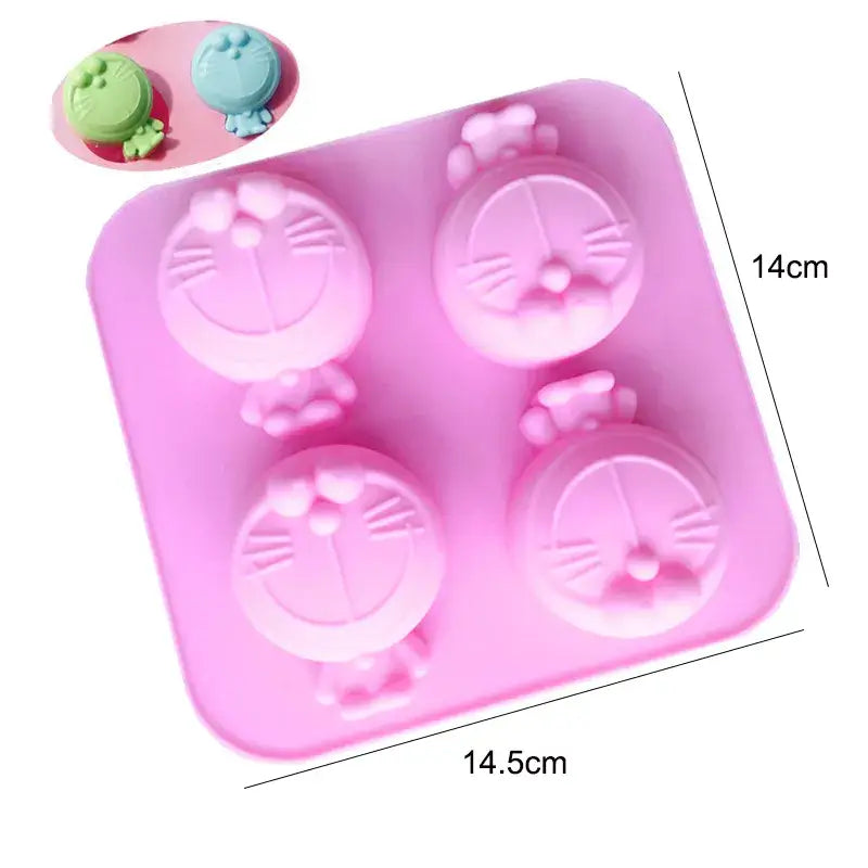 a close up of a pink tray with four cat shaped cupcakes