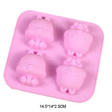 a close up of a pink tray with four little pigs in it