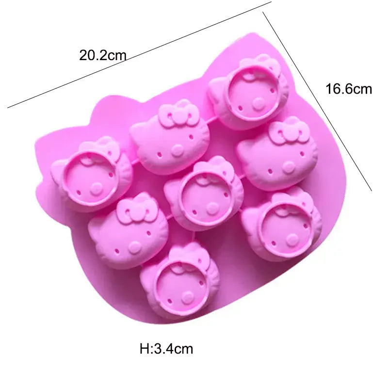 a close up of a pink tray with hello kitty shaped chocolate molds