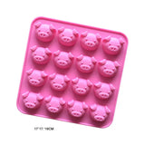 a close up of a pink tray with pig shaped chocolates in it