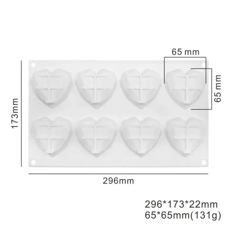 a close up of a plastic heart shaped mold with a cross on it