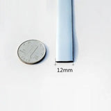 a close up of a quarter of a dime next to a thin piece of metal