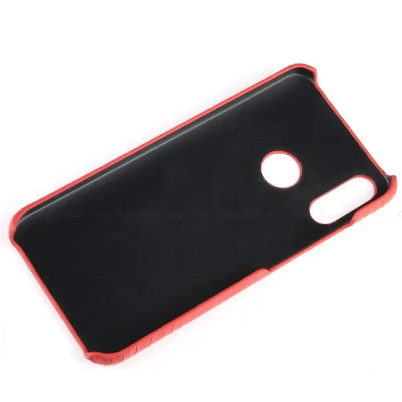 a close up of a red and black case on a white surface