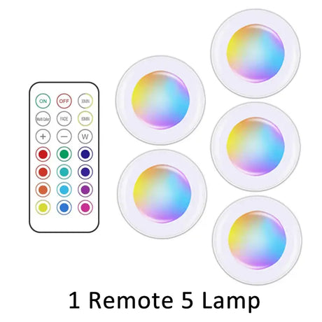 A close up of a remote control and five different colored lights