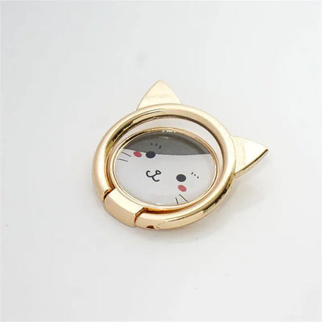 a cat shaped pocket watch with a gold case