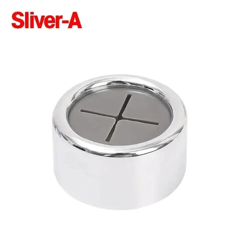 a close up of a silver metal button with a white background