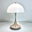 A close up of a table lamp on a white surface