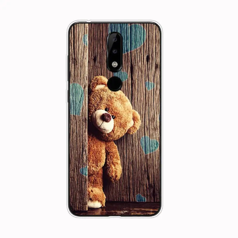 a close up of a teddy bear on a wooden surface