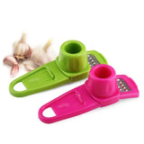 a close up of two different colored garlic cutters with a garlic peeler