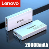 a close up of two white batteries on a table with a red lenovo logo