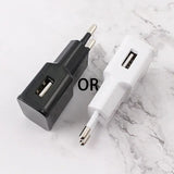a white and black charger on a marble surface