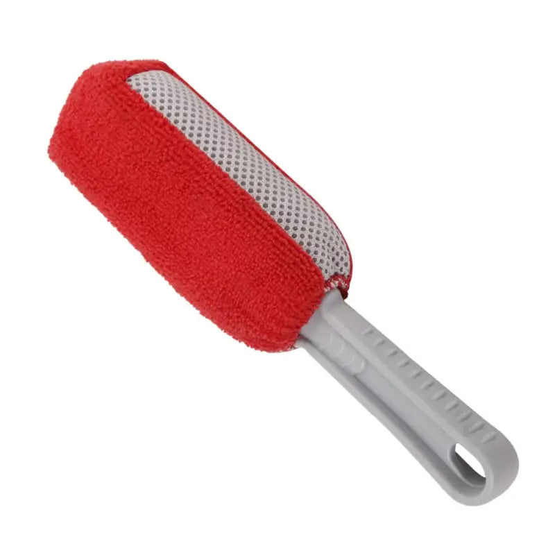a close up of a red and white brush with a handle