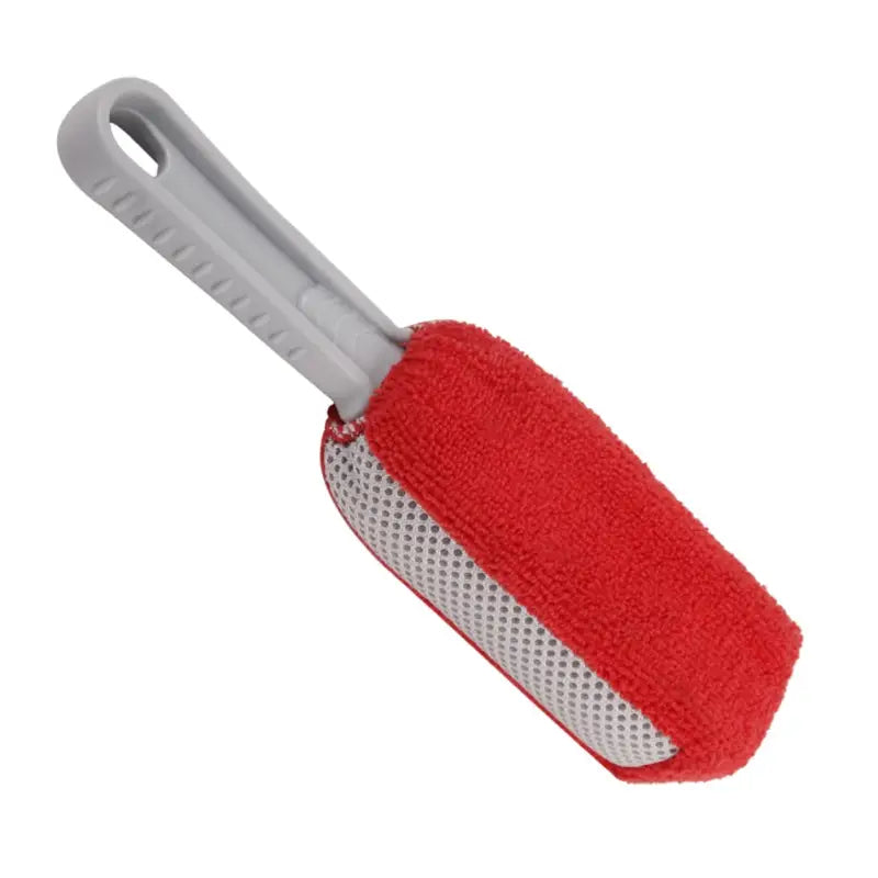 a close up of a red and white brush with a white handle