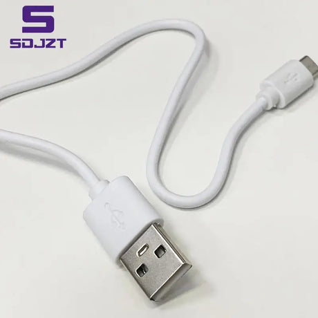 a close up of a white usb cable connected to a white phone