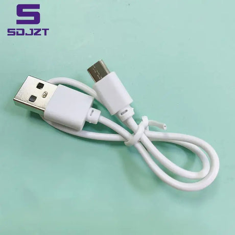 a close up of a white usb cable connected to a white phone