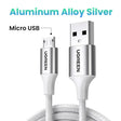 A close up of a white cable connected to a micro usb