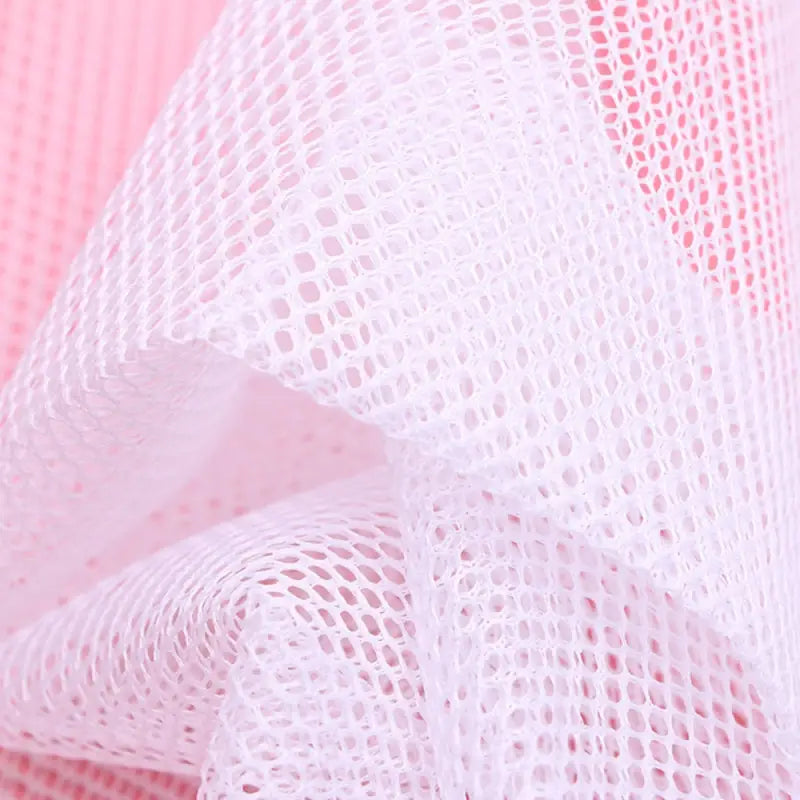 a white mesh fabric with a pink background