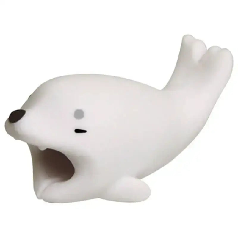 a close up of a white seal toy with a black nose