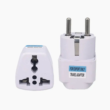 A close up of a white travel adapter with two plugs