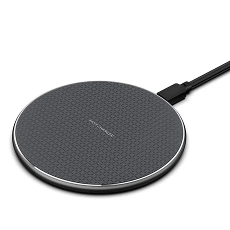 a close up of a wireless charger on a white surface