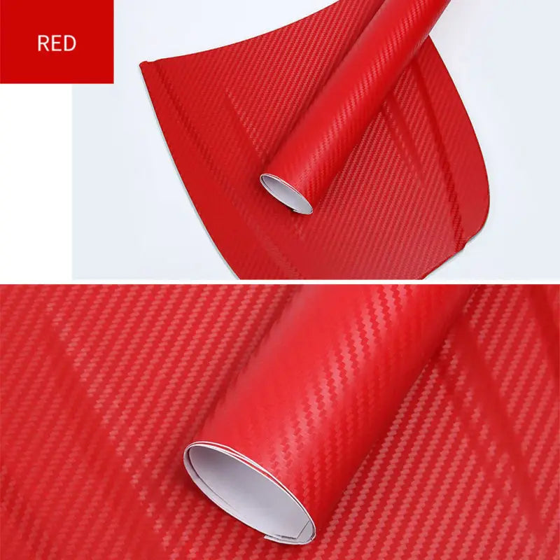 a close up of a red car wrapper with a roll of red carbon fiber