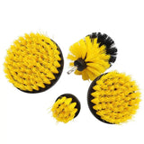 three yellow and black brushes with black handles on a white background