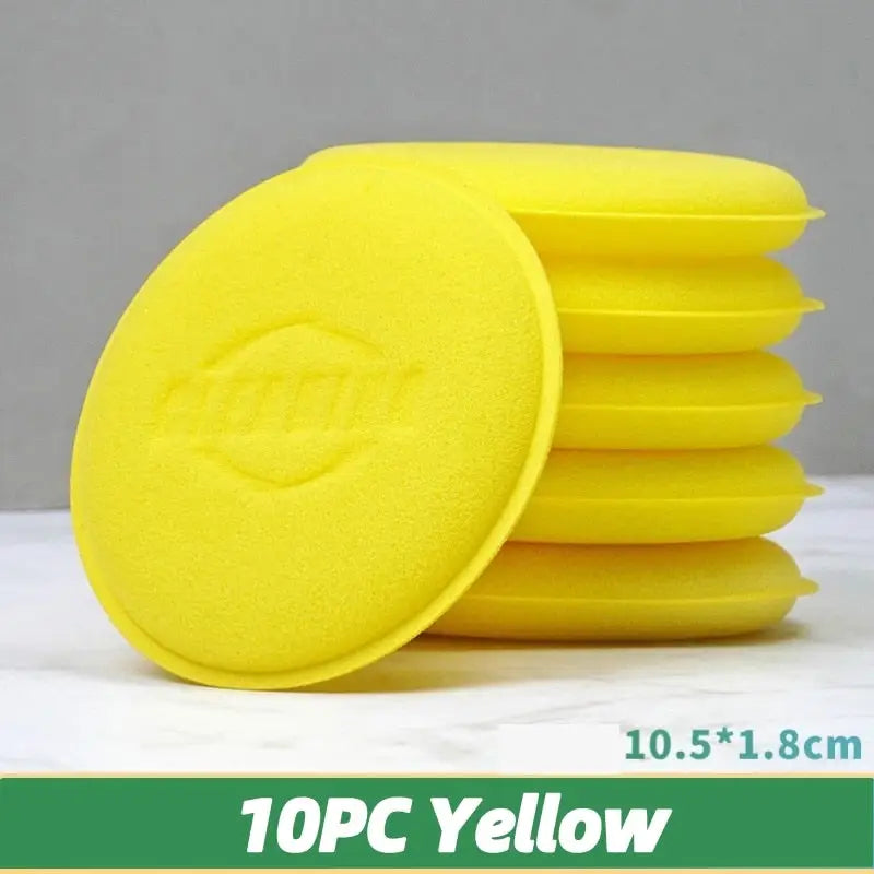 a pile of yellow sponges on a white table