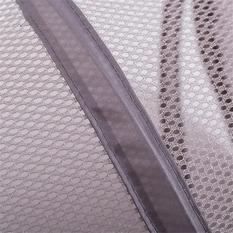 a close up of the zipper on a grey and white quilt