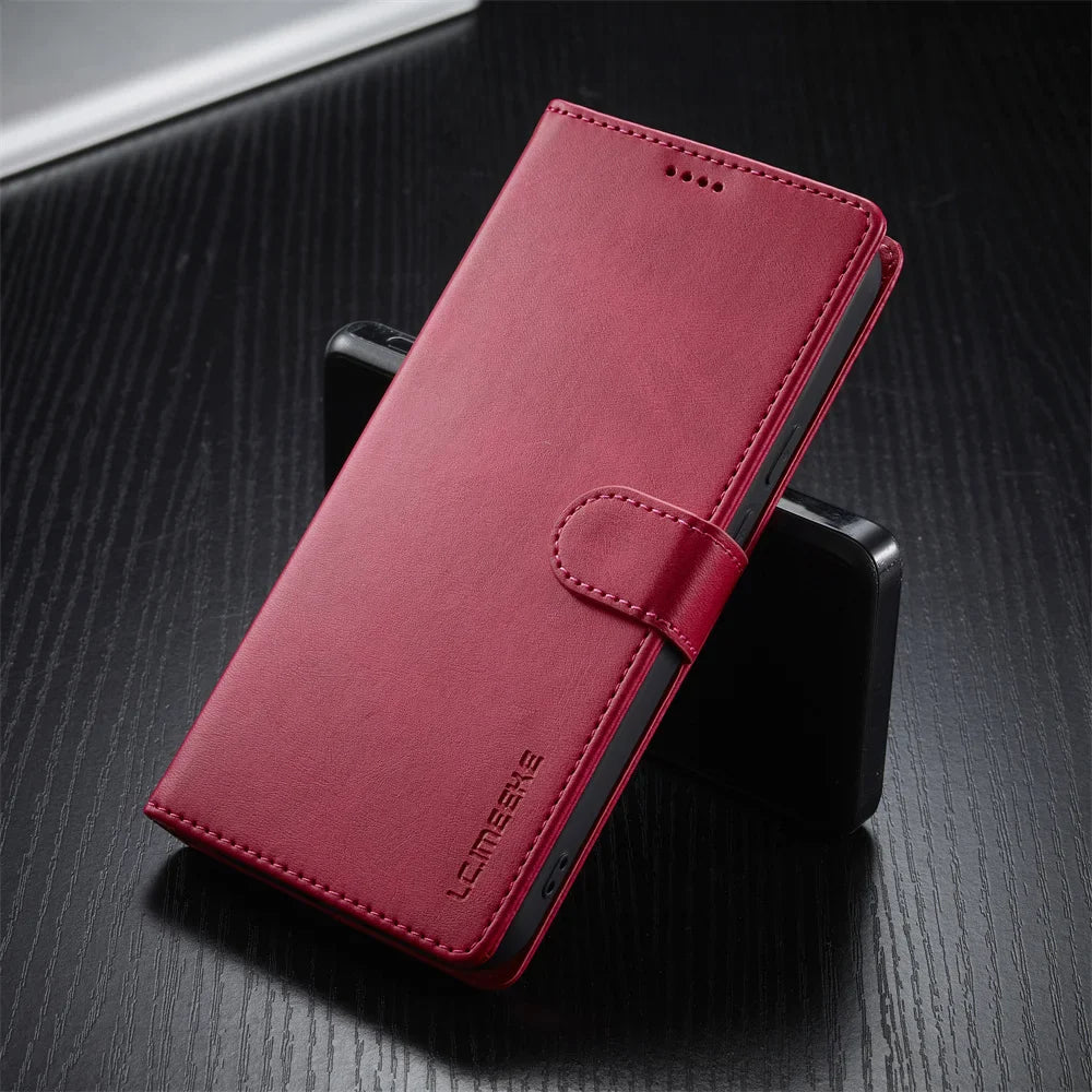 A closed, red leatherette phone case with a magnetic strap.