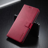A closed, red leatherette phone case with a magnetic strap.