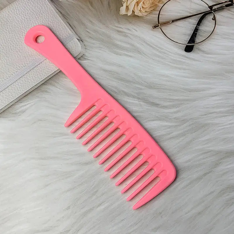 a pink comb with a white purse and glasses