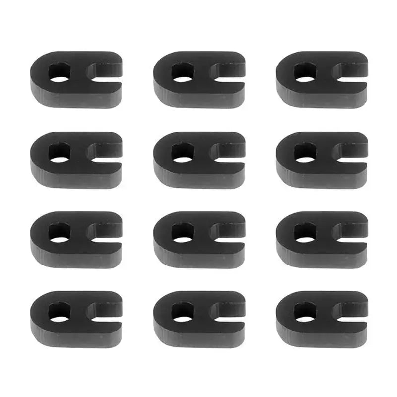 a close up of a bunch of black plastic clips on a white surface