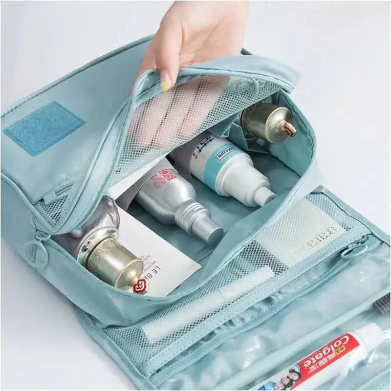 a person putting a toothpas in a bag