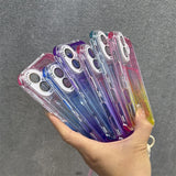 A collection of clear, gradient-colored smartphone cases with reinforced camera cutouts and lanyard attachments.